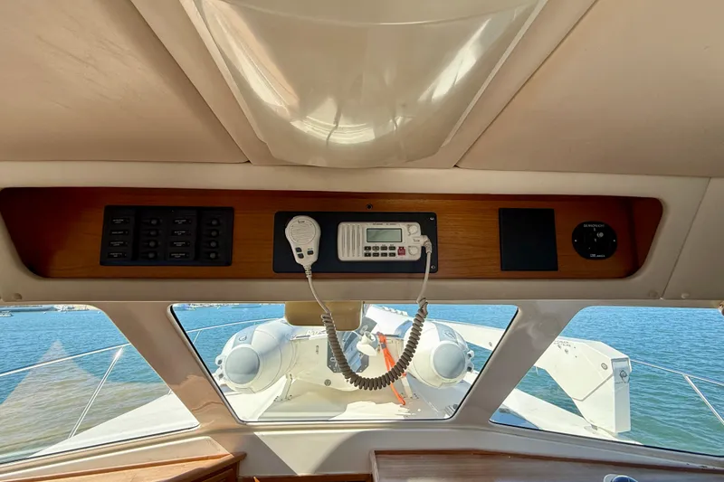Slide: The Image of Interior view of 1998 Riviera 43 Open Flybridge yacht with control panel and sea view. - 25