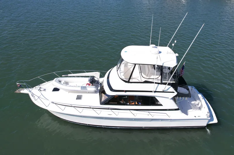 Slide: The Image of 1998 Riviera 43 Open Flybridge yacht on calm water, aerial view. - 3