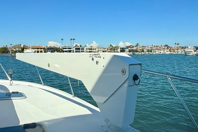 Slide: The Image of 1998 Riviera 43 Open Flybridge yacht with scenic waterfront view. - 42