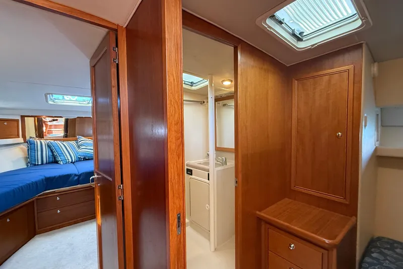 Slide: The Image of Interior of 1998 Riviera 43 Open Flybridge yacht with wood paneling and cozy bedroom. - 43