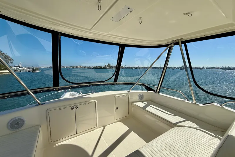 Slide: The Image of Interior view of 1998 Riviera 43 Open Flybridge overlooking a scenic harbor. - 44