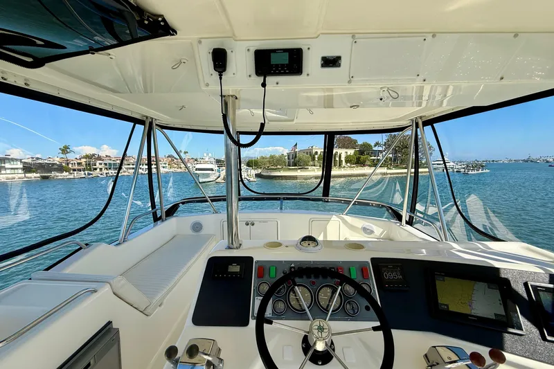 Slide: The Image of Interior view of 1998 Riviera 43 Open Flybridge yacht, showcasing helm and waterfront scenery. - 45