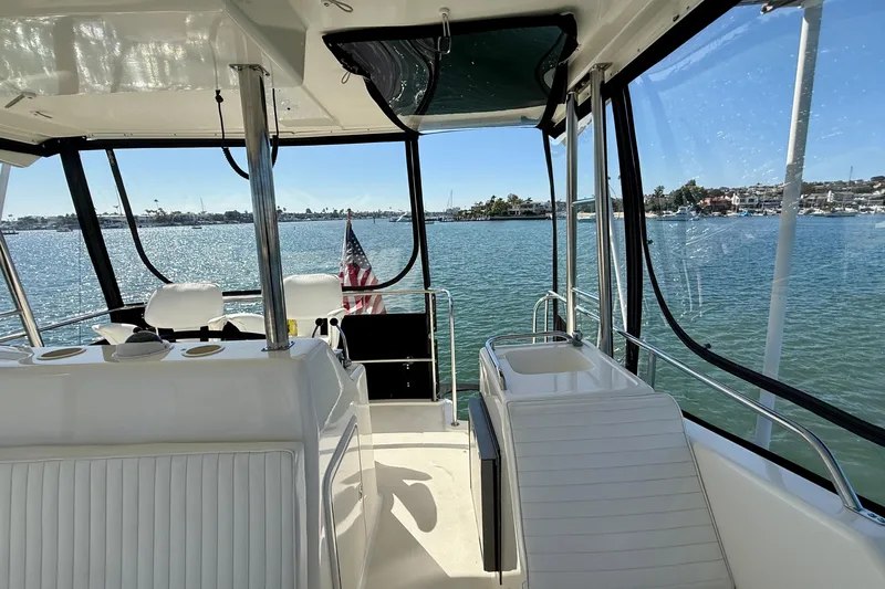 Slide: The Image of 1998 Riviera 43 Open Flybridge yacht interior with ocean view and American flag. - 48