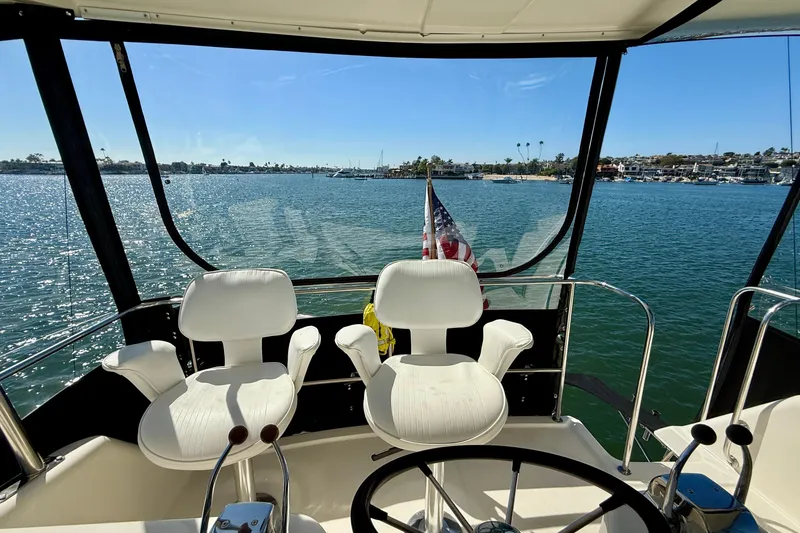 Slide: The Image of 1998 Riviera 43 Open Flybridge yacht interior with ocean view and steering wheel. - 49