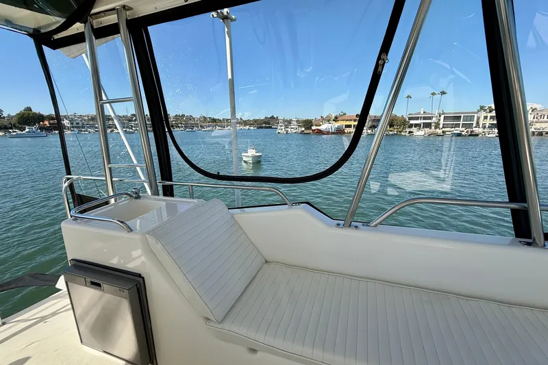 Slide: The Image of 1998 Riviera 43 Open Flybridge interior with waterfront view, featuring sleek seating and modern design. - 50