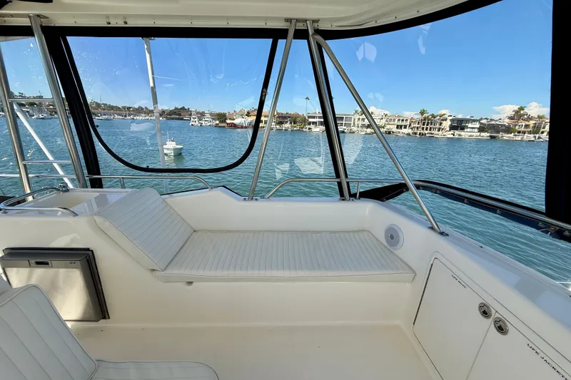 Slide: The Image of 1998 Riviera 43 Open Flybridge interior with waterfront view, featuring comfortable seating and sleek design. - 51