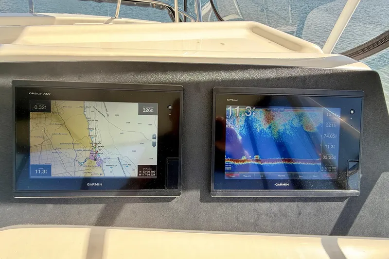 Slide: The Image of Garmin navigation screens on 1998 Riviera 43 Open Flybridge boat dashboard. - 54