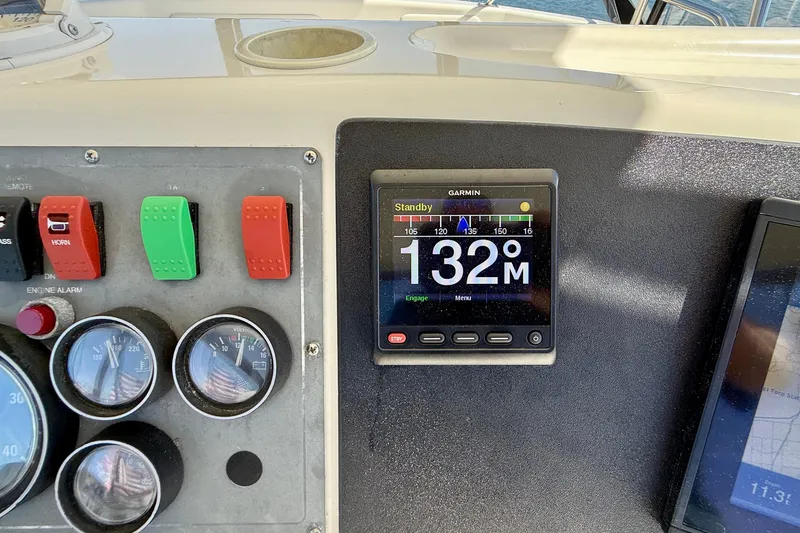Slide: The Image of Control panel of 1998 Riviera 43 Open Flybridge with Garmin display and gauges. - 55