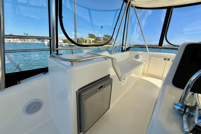 Slide: The Image of 1998 Riviera 43 Open Flybridge interior with ocean view, featuring seating and storage. - 58