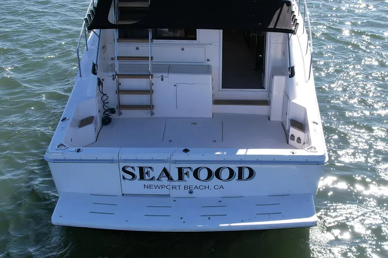 Slide: The Image of Riviera 43 Open Flybridge 1998 boat with "SEAFOOD" signage, Newport Beach, CA. - 6