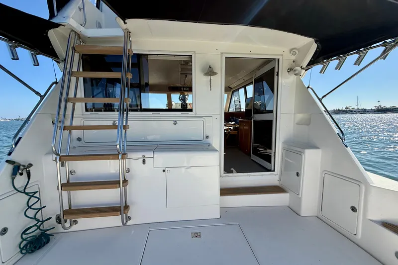 Slide: The Image of 1998 Riviera 43 Open Flybridge yacht interior with stairs and ocean view. - 61