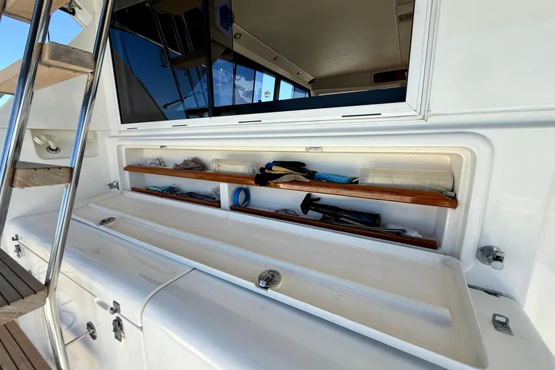 Slide: The Image of Storage compartment on a 1998 Riviera 43 Open Flybridge yacht, featuring shelves and equipment. - 63