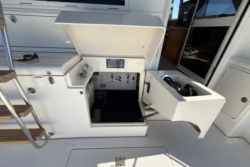 Slide: The Image of 1998 Riviera 43 Open Flybridge yacht deck with open storage compartment. - 64