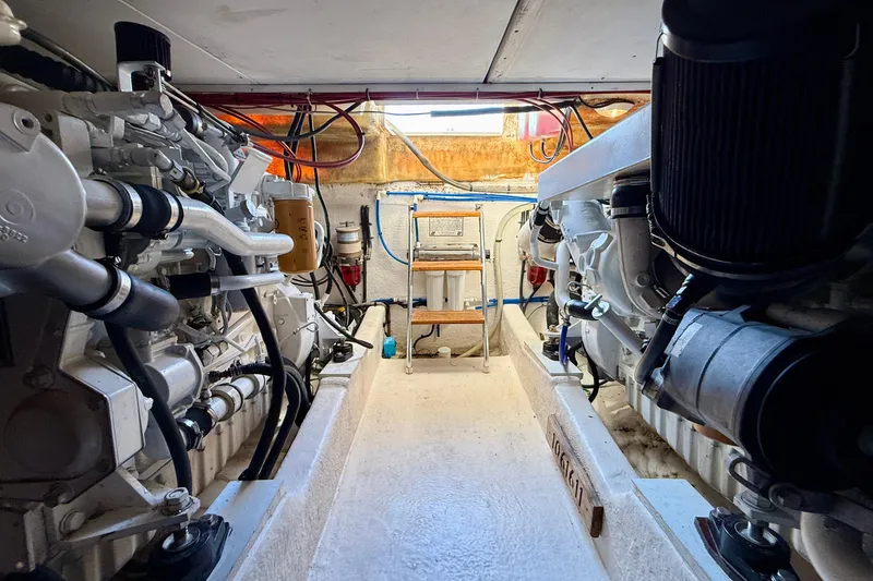 Slide: The Image of Engine room of 1998 Riviera 43 Open Flybridge yacht, showcasing dual engines and mechanical components. - 69