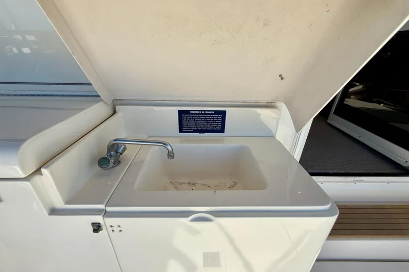 Slide: The Image of Sink on 1998 Riviera 43 Open Flybridge yacht, featuring a compact design and faucet. - 70