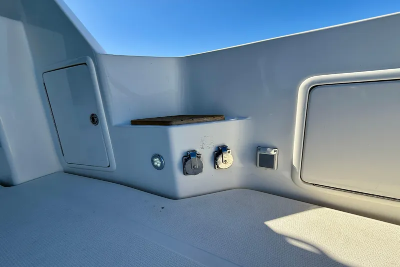 Slide: The Image of 1998 Riviera 43 Open Flybridge boat deck with utility panel and storage compartments. - 74