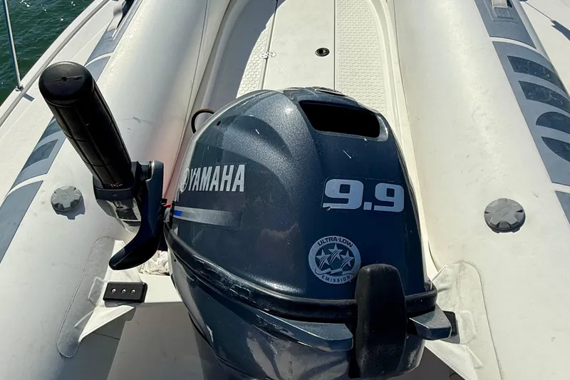 Slide: The Image of Yamaha 9.9 outboard motor on a 1998 Riviera 43 Open Flybridge boat. - 76