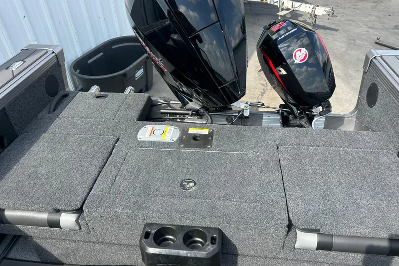 Slide: The Image of 2026 Lund 1975 Tyee boat with dual Mercury outboard motors, gray carpeted deck. - 18