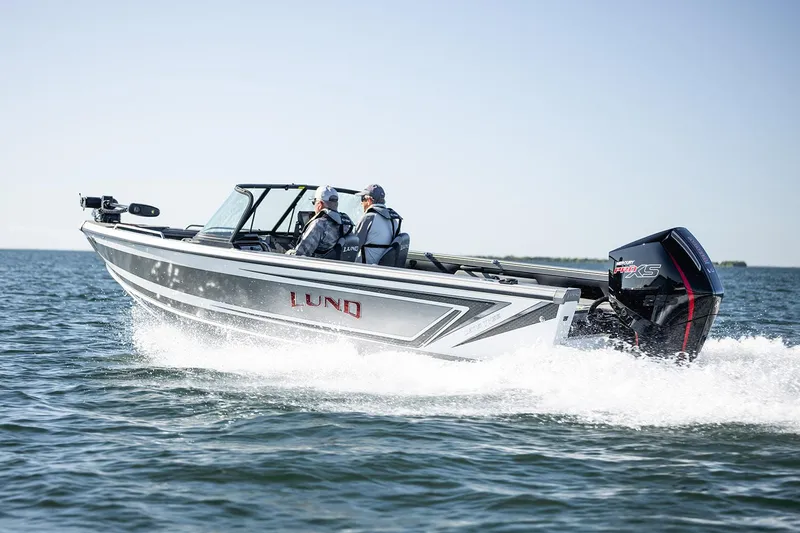 Slide: The Image of Manufacturer Provided Image: 2025 Lund 1975 Tyee boat cruising on open water, featuring sleek design and powerful engine. - 31