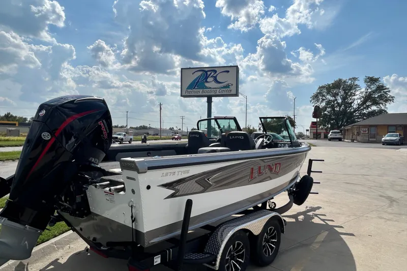 Slide: The Image of 2026 Lund 1975 Tyee boat at Premier Boating Center under a sunny sky. - 4