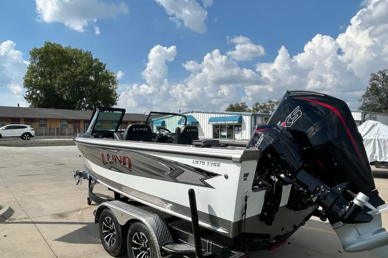 Slide: The Image of Lund 1975 Tyee 2026 boat on trailer under blue sky. - 5