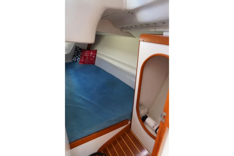 Slide: The Image of Cozy cabin interior of 2007 J Boats J/124 with blue bedding and wooden accents. - 14