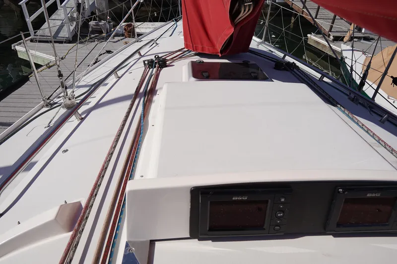 Slide: The Image of 2007 J Boats J/124 sailboat deck with red sail cover and navigation instruments. - 15