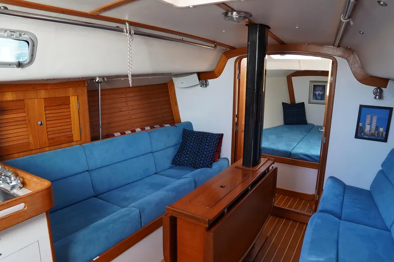 Slide: The Image of Interior of 2007 J Boats J/124 sailboat with blue seating and wooden accents. - 5