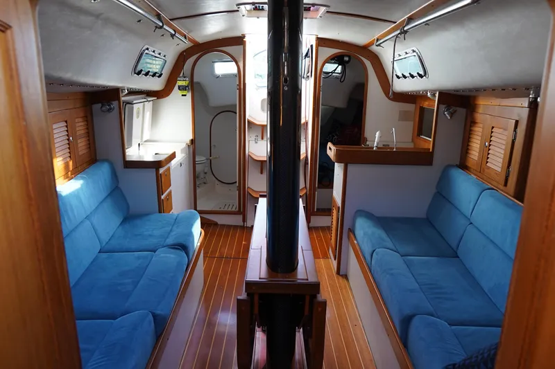 Slide: The Image of Interior of 2007 J Boats J/124 sailboat with blue seating and wooden finishes. - 9