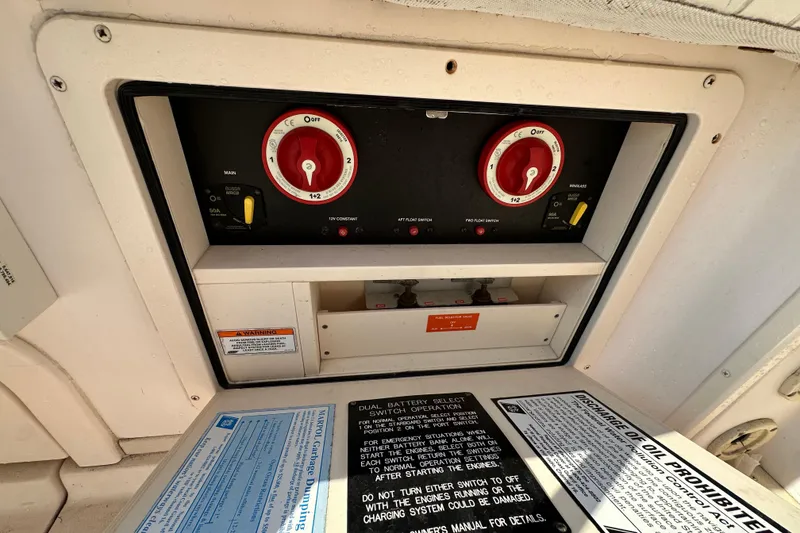 Slide: The Image of Control panel of a 2008 Grady White Express boat with battery switches and safety instructions. - 11