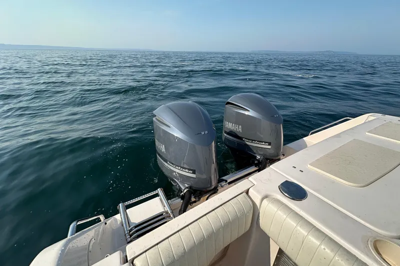 Slide: The Image of 2008 Grady White Express boat with twin Yamaha outboard motors on open water. - 19