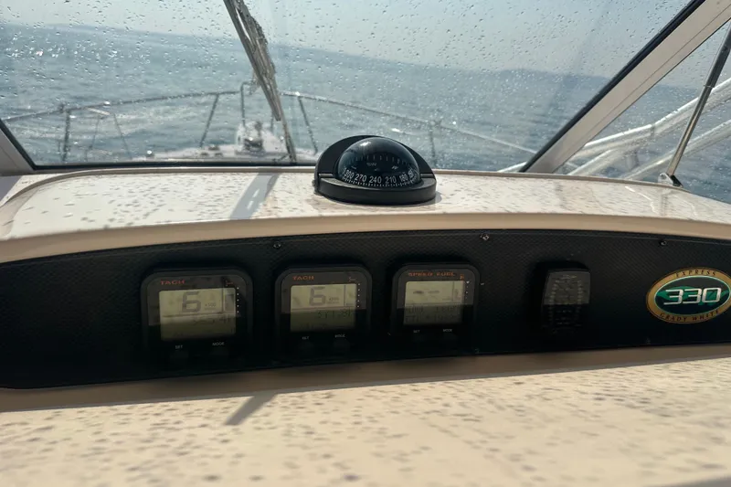 Slide: The Image of Dashboard of a 2008 Grady White Express boat with gauges and compass. - 25