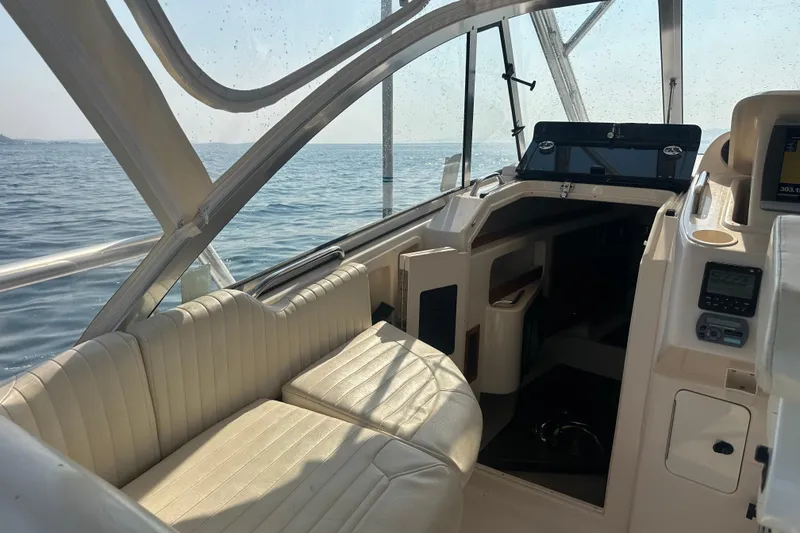 Slide: The Image of 2008 Grady White Express boat interior with seating, dashboard, and ocean view. - 33