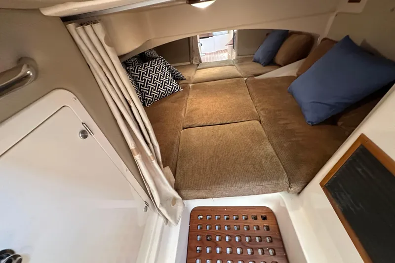 Slide: The Image of 2008 Grady White Express cabin interior with cozy bedding and decorative pillows. - 46