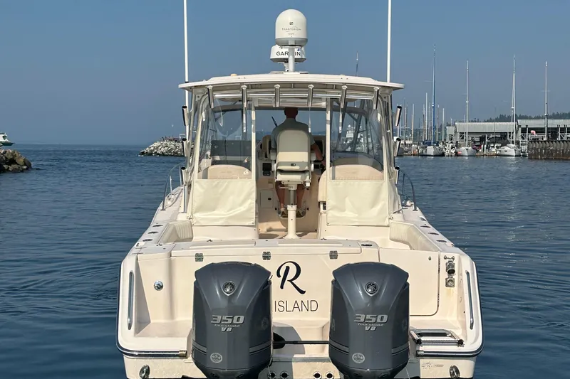 Slide: The Image of 2008 Grady White Express boat with twin 350 V8 engines docked in a marina. - 7