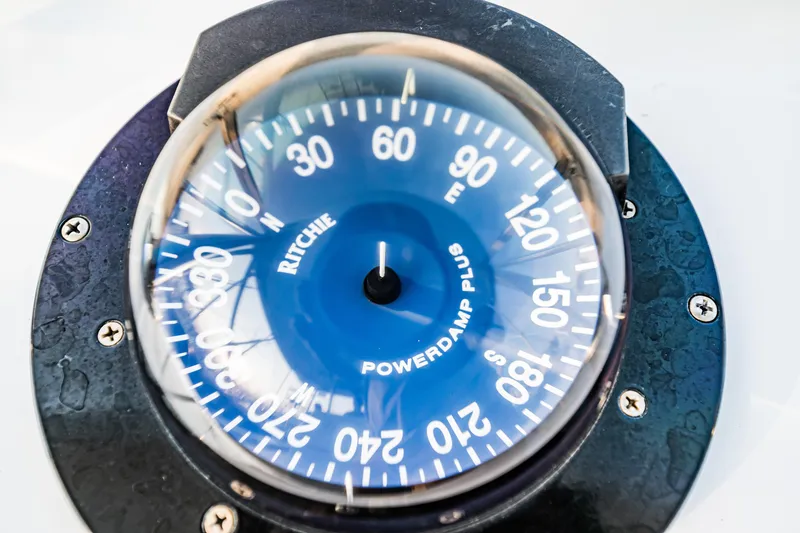 Slide: The Image of Compass on 1988 Buddy Davis 47 Convertible boat, displaying cardinal directions. - 36