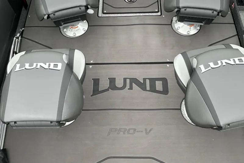 Slide: The Image of 2026 Lund 1975 Pro-V boat interior with branded seats and flooring. - 10