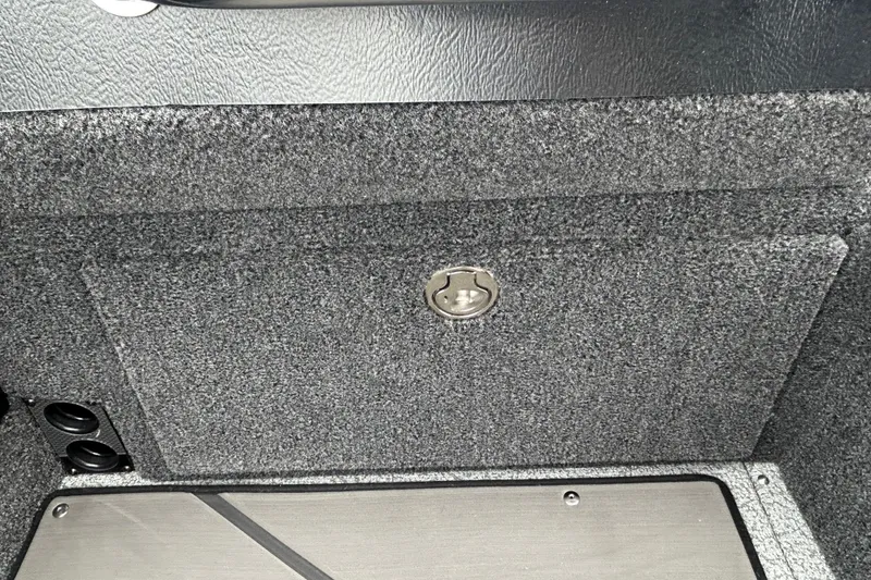 Slide: The Image of Interior view of 2026 Lund 1975 Pro-V boat storage compartment with carpeted finish. - 15