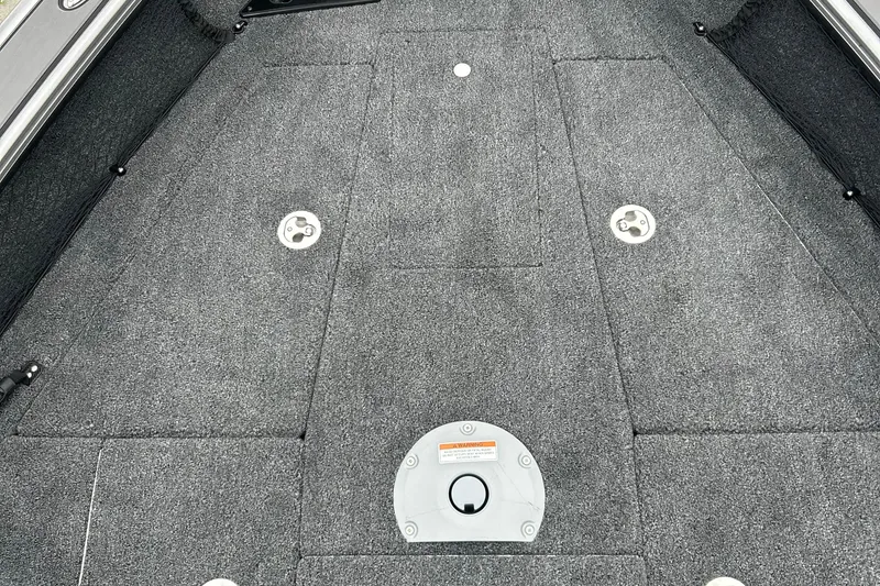 Slide: The Image of Interior view of 2026 Lund 1975 Pro-V boat deck with gray carpeting. - 17