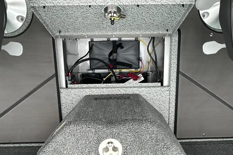 Slide: The Image of Interior view of 2026 Lund 1975 Pro-V boat showing wiring and storage compartment. - 19