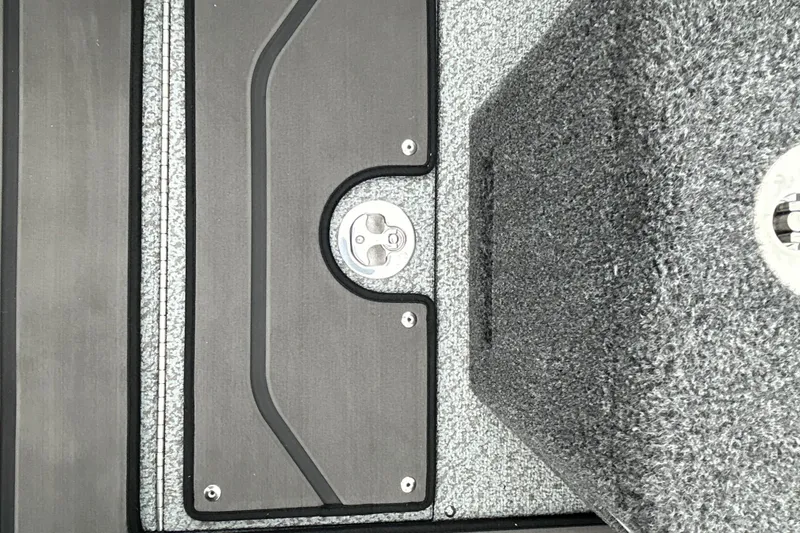 Slide: The Image of Interior detail of 2026 Lund 1975 Pro-V boat, featuring textured flooring and metal latch. - 20