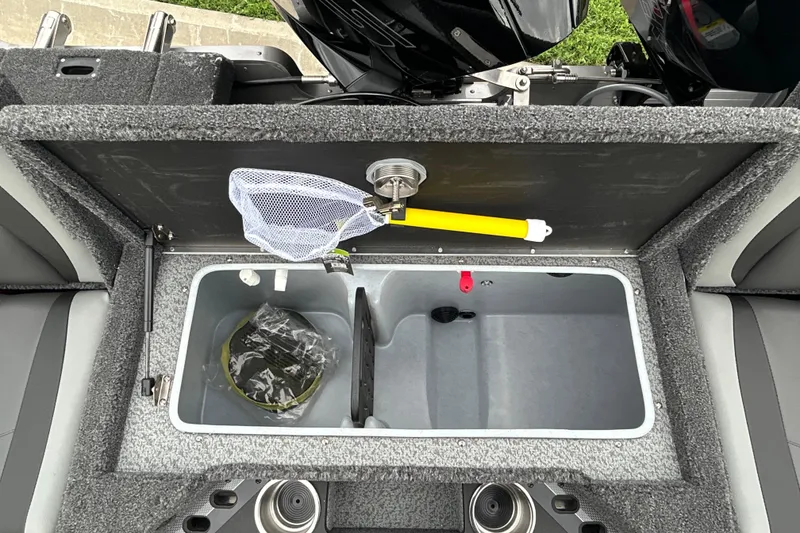 Slide: The Image of Interior view of 2026 Lund 1975 Pro-V boat's storage compartment with fishing net. - 22