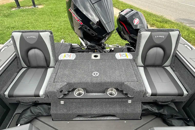 Slide: The Image of 2026 Lund 1975 Pro-V boat interior with dual seats and Mercury outboard motor. - 24