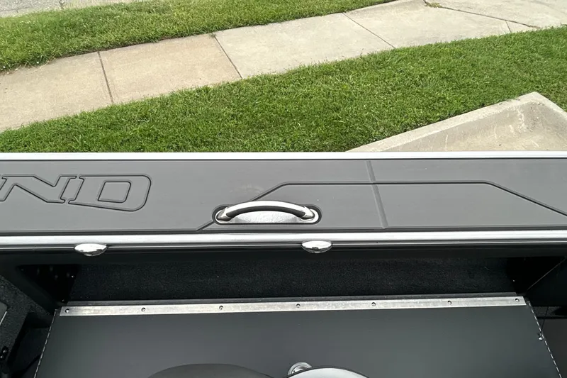 Slide: The Image of 2026 Lund 1975 Pro-V boat interior with sleek design and handle detail. - 28