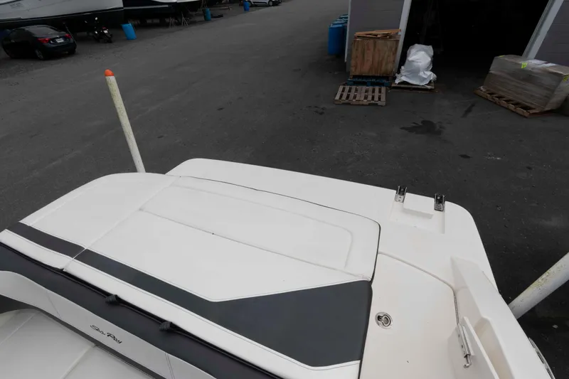 Slide: The Image of 2018 Sea Ray SPX 190 boat rear deck in a marina setting. - 10