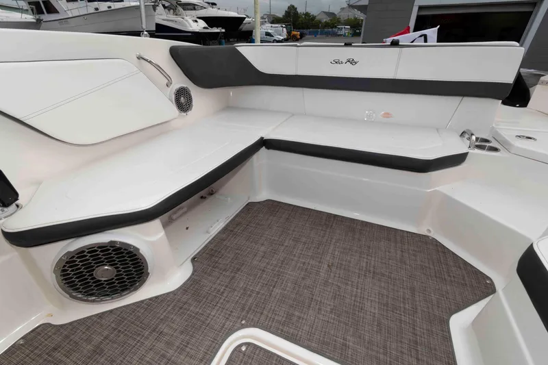 Slide: The Image of 2018 Sea Ray SPX 190 boat interior with cushioned seating and speaker system. - 11