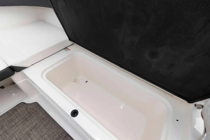 Slide: The Image of 2018 Sea Ray SPX 190 boat storage compartment with cushioned seating. - 13