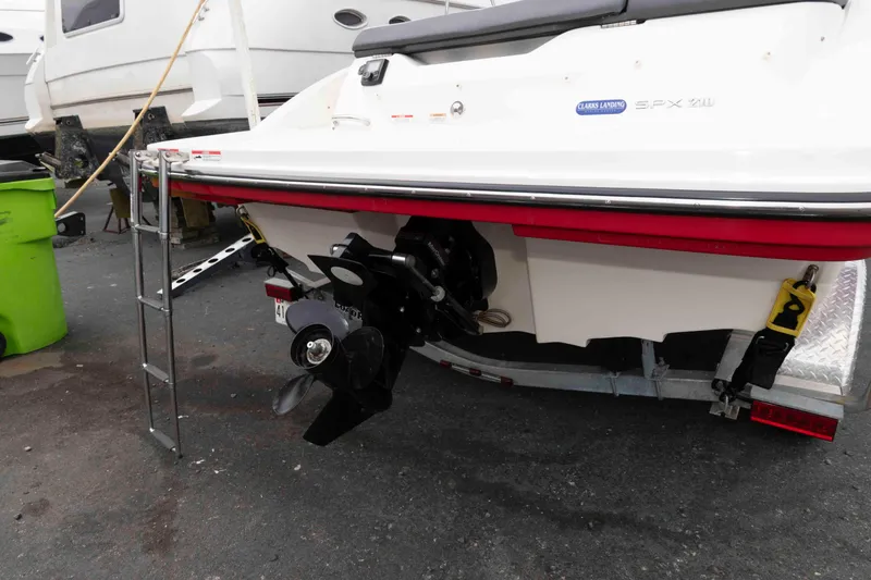 Slide: The Image of 2018 Sea Ray SPX 190 boat rear view with propeller and ladder. - 16