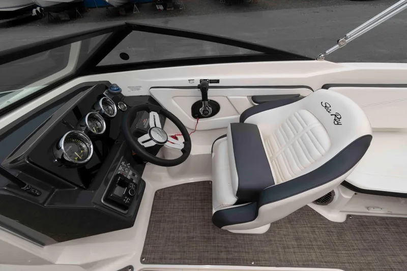 Slide: The Image of 2018 Sea Ray SPX 190 boat interior with steering wheel and branded seat. - 6