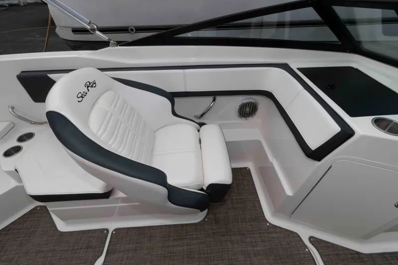 Slide: The Image of 2018 Sea Ray SPX 190 boat interior with white and black seating, cup holders, and speaker. - 8